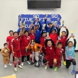 Wolfpack holding trophies